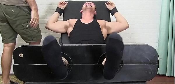  Muscular hunk laughs while having his feet and toes tickled